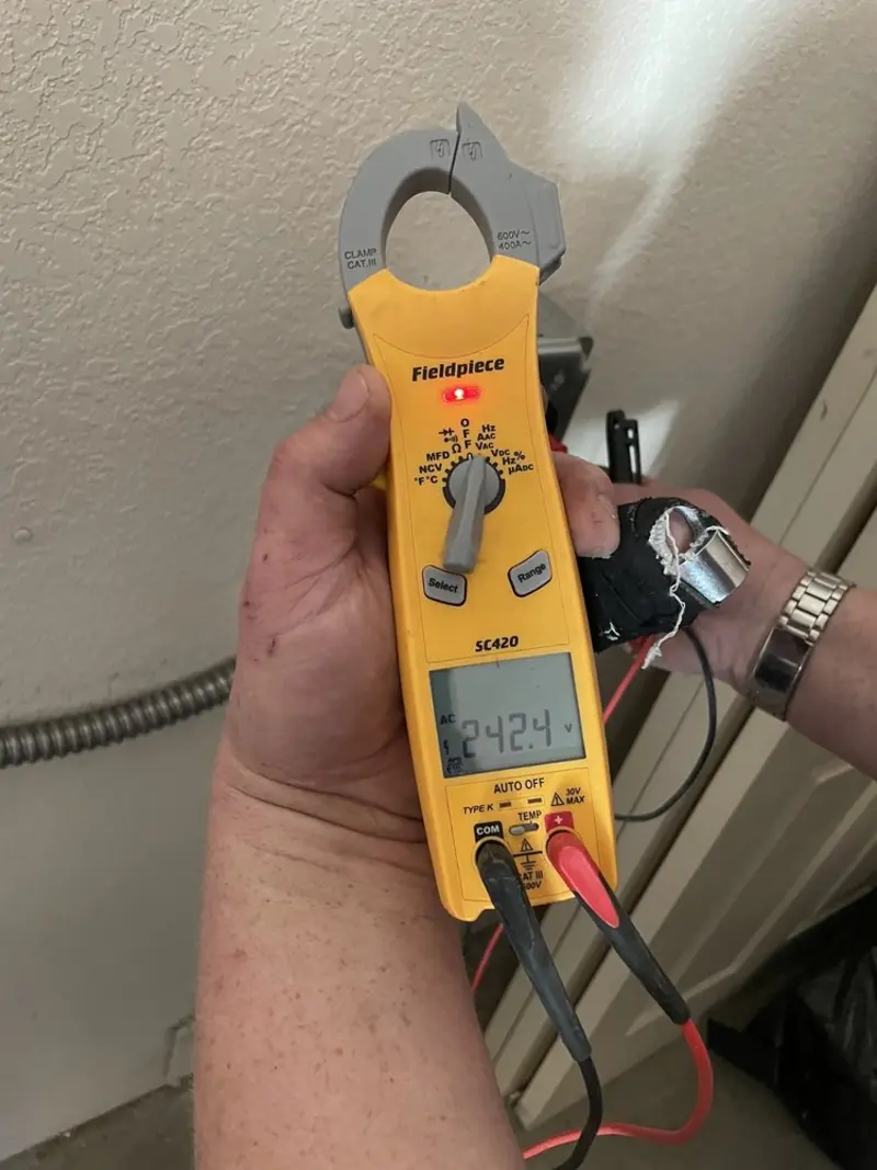 Voltage testing with clamp meter during Recessed Lighting Installation in Wright